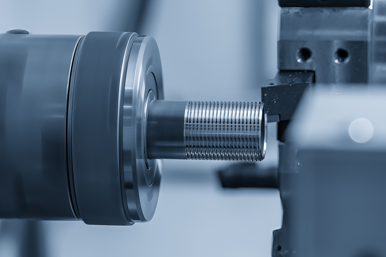 Close up scene the CNC lathe machine thread cutting at the end of metal pipe parts