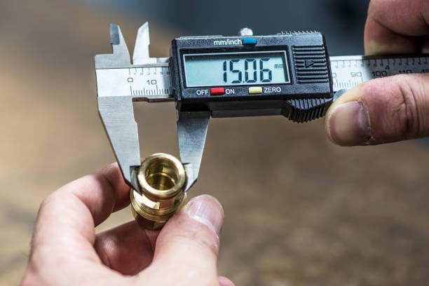 Using a vernier caliper to measure the brass part